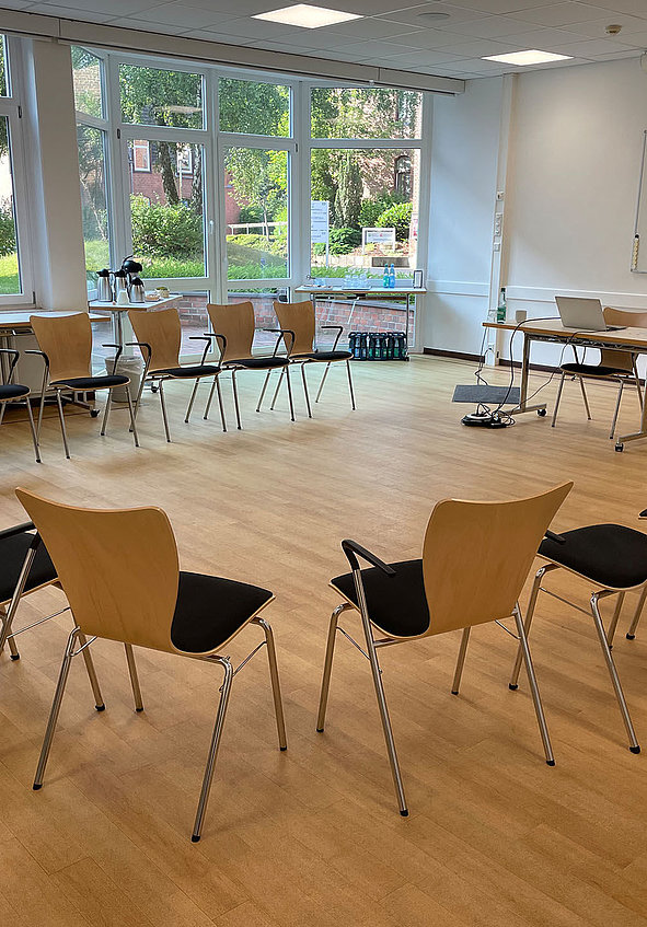 Stuhlkreis in Seminarraum mit Laptop und Flipchart für Coaching
